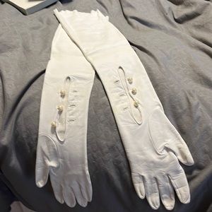 White long leather gloves with pearl buttons.